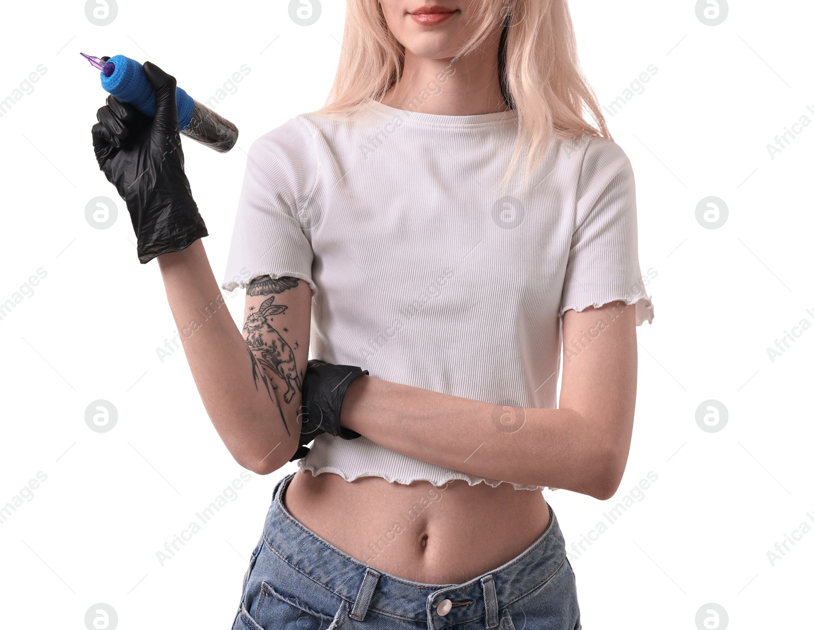 Photo of Professional artist in gloves holding tattoo machine on white background, closeup