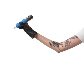 Photo of Professional artist in gloves holding tattoo machine on white background, closeup