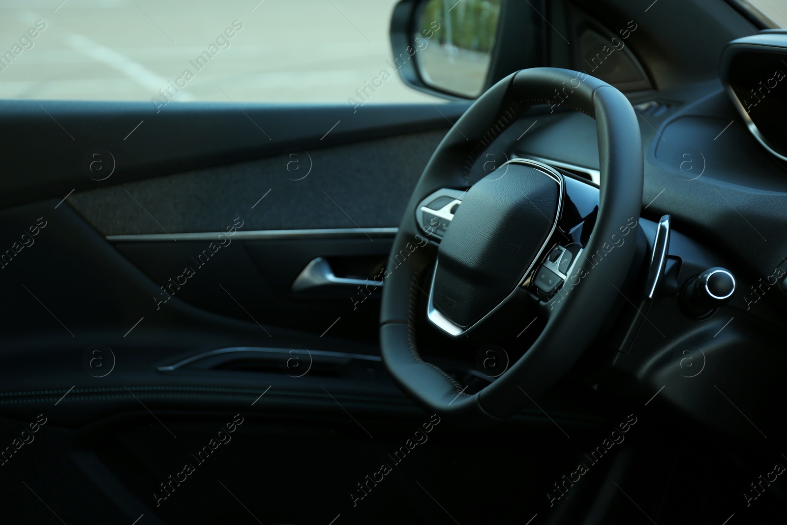 Photo of Steering wheel and dashboard inside of modern luxury car, closeup. Space for text