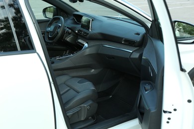 Photo of Steering wheel and dashboard inside of modern luxury car