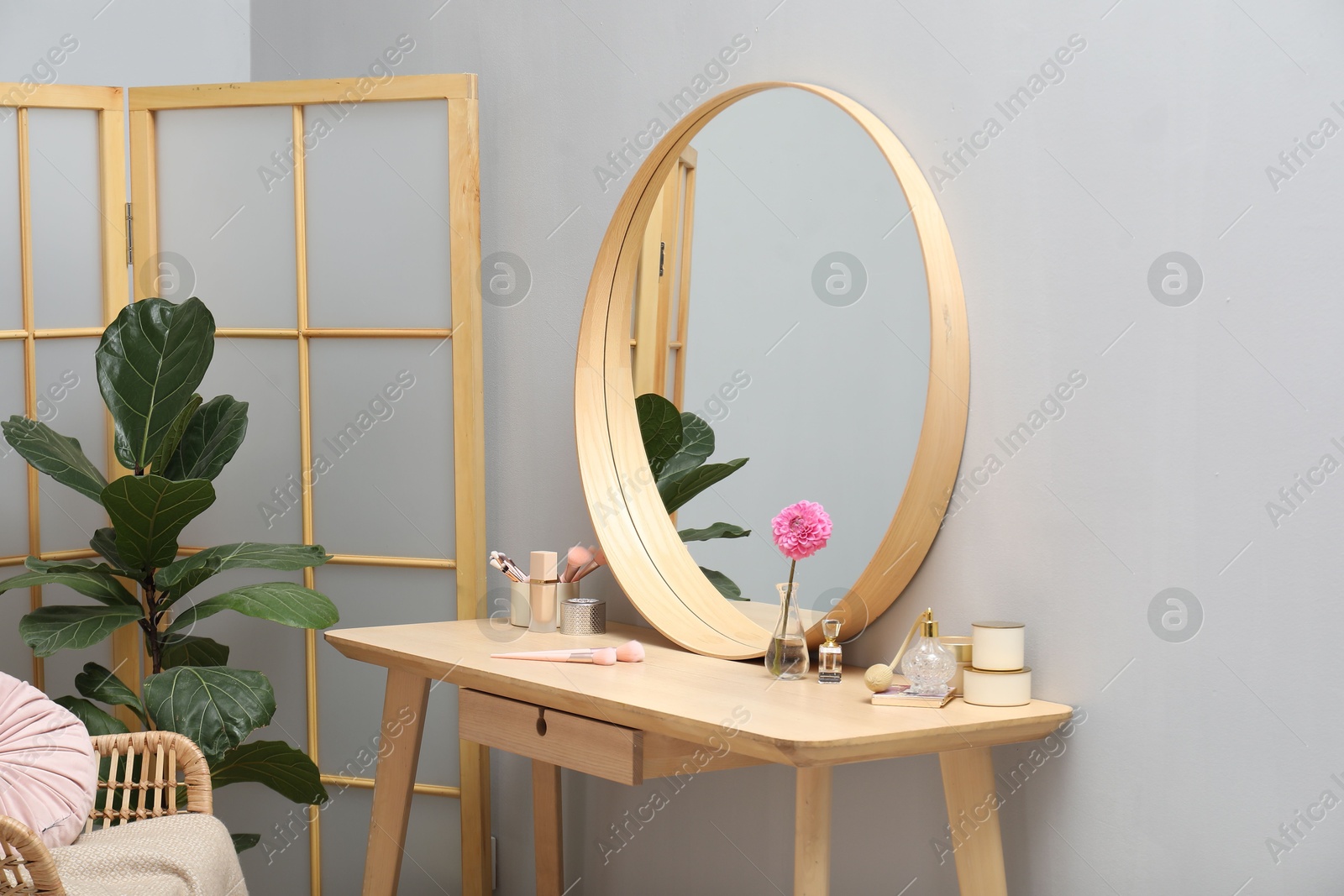 Photo of Mirror, dressing table, houseplant, folding screen and chair indoors. Interior design