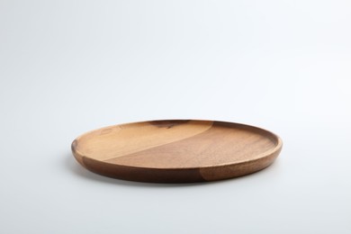 One wooden plate on white background. Tableware