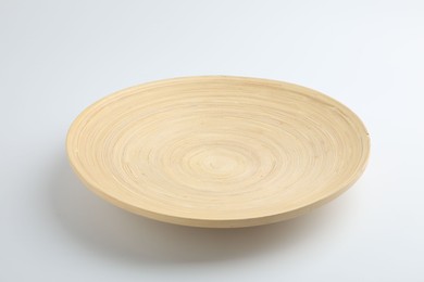 Photo of One wooden plate on white background. Tableware