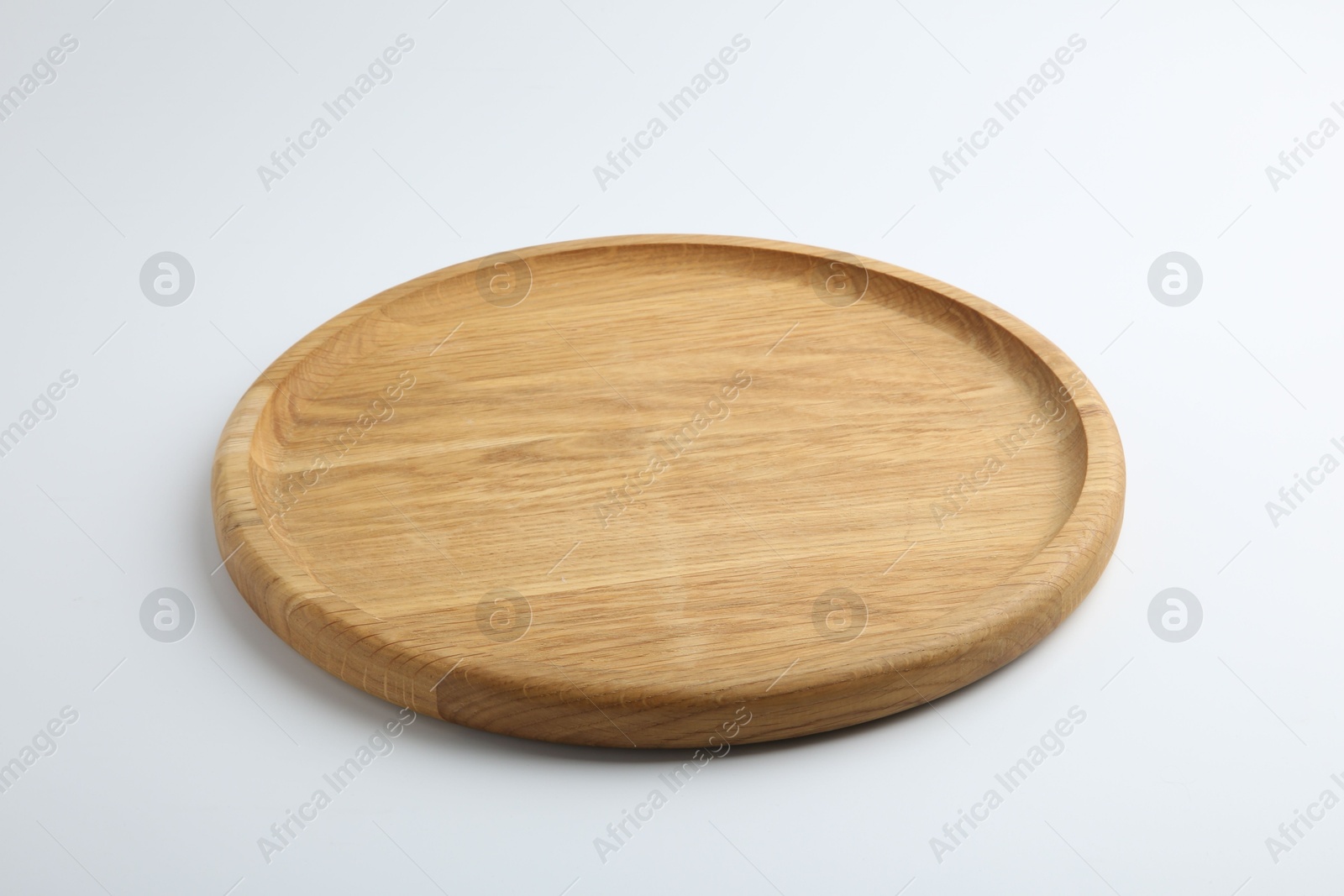 Photo of One wooden plate on white background. Tableware