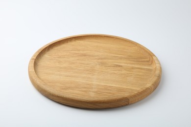 One wooden plate on white background. Tableware