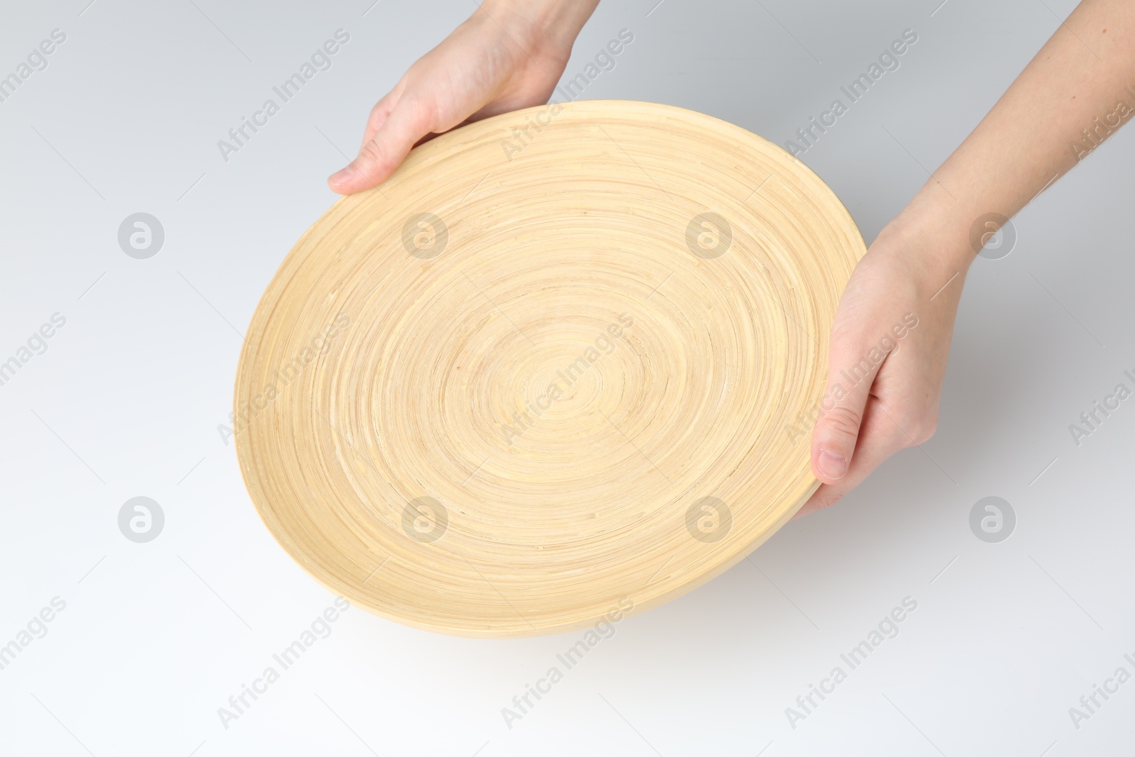 Photo of Woman holding wooden plate on white background, closeup