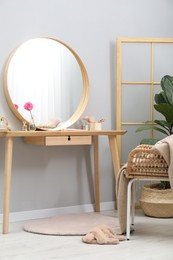 Photo of Mirror, dressing table, houseplant, folding screen and chair indoors. Interior design