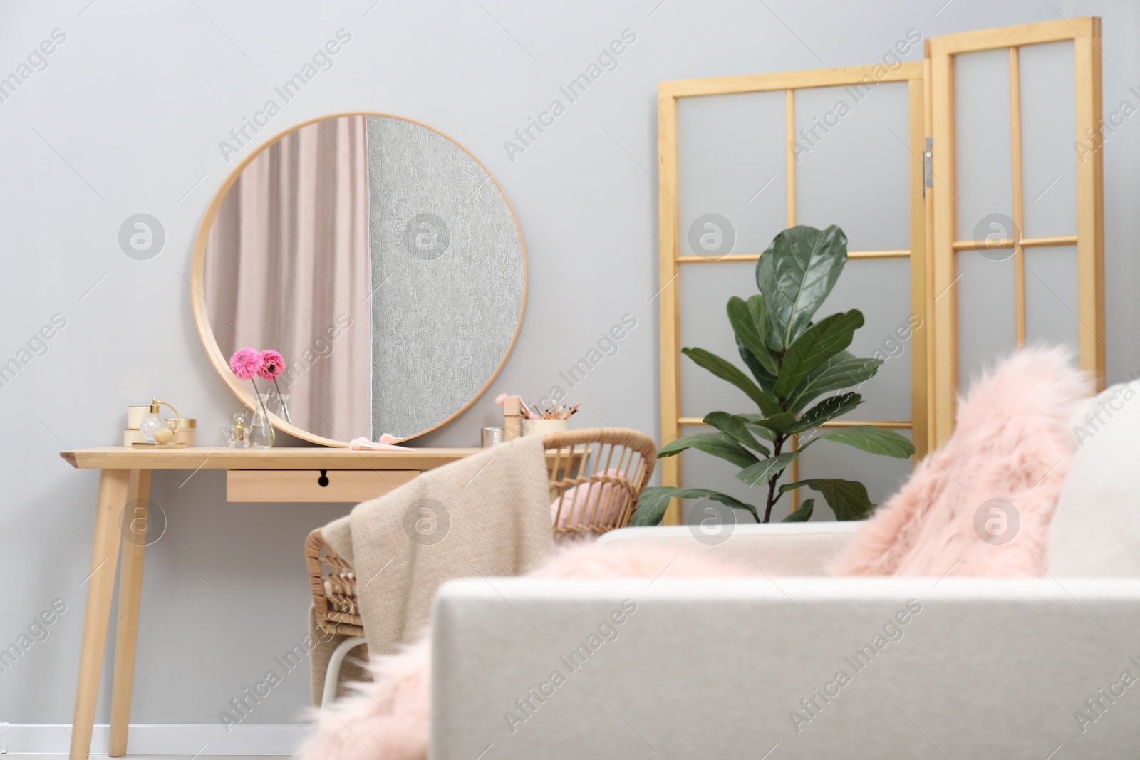 Photo of Mirror, dressing table, houseplant, folding screen and chair indoors. Interior design