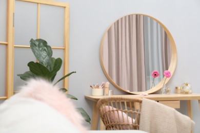 Mirror, dressing table, houseplant, folding screen and chair indoors. Interior design