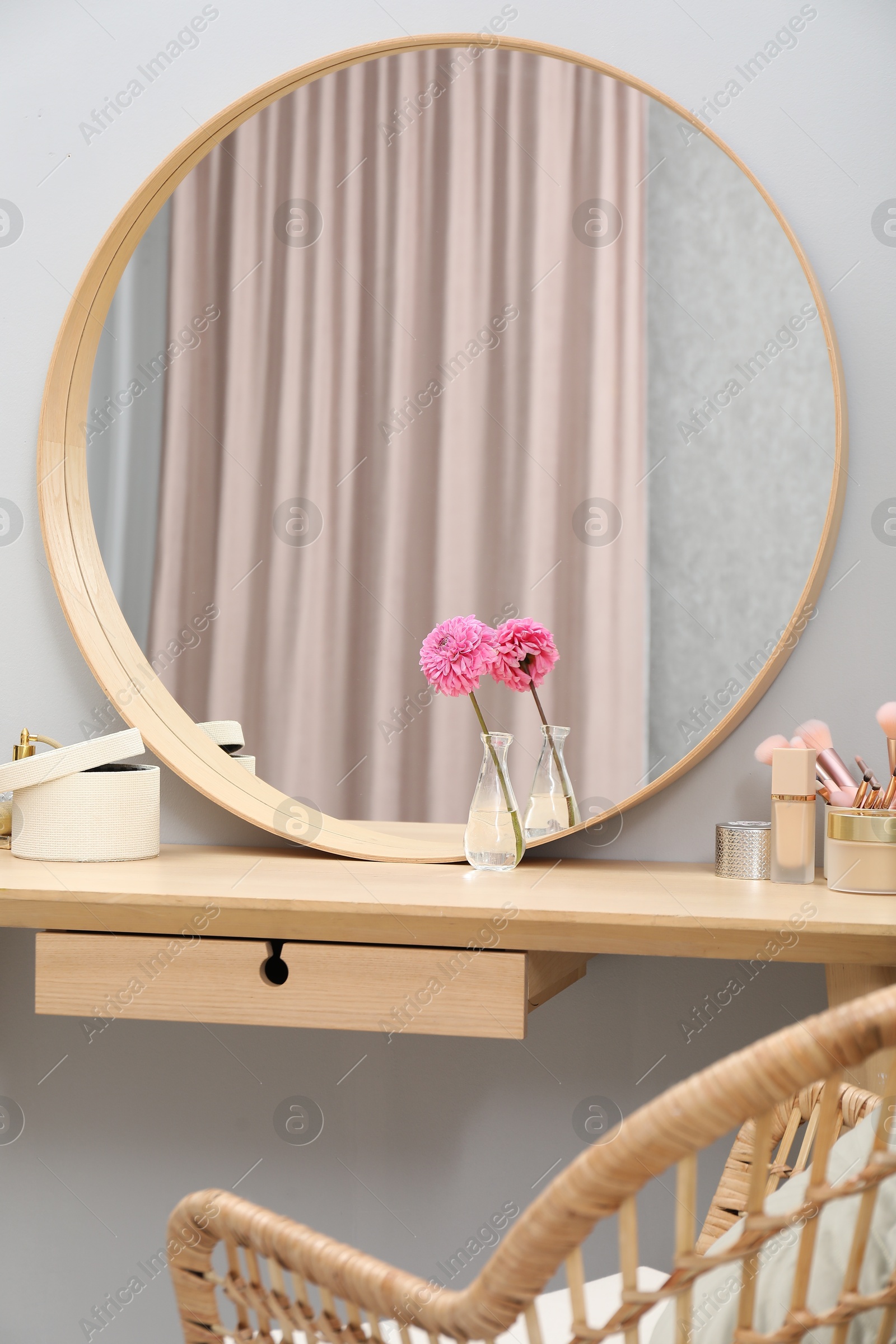 Photo of Mirror, dressing table and chair indoors. Interior design