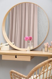 Photo of Mirror, dressing table and chair indoors. Interior design