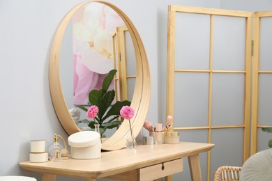 Photo of Mirror, dressing table and folding screen indoors. Interior design