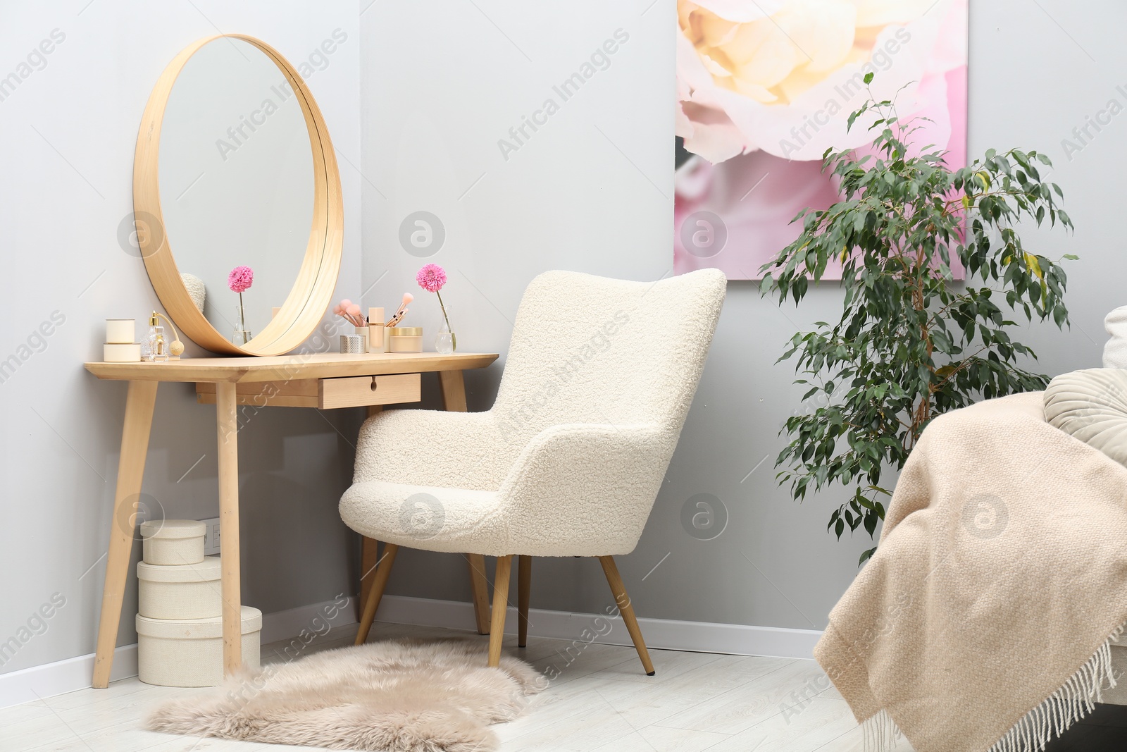 Photo of Mirror, dressing table, houseplant and armchair indoors. Interior design