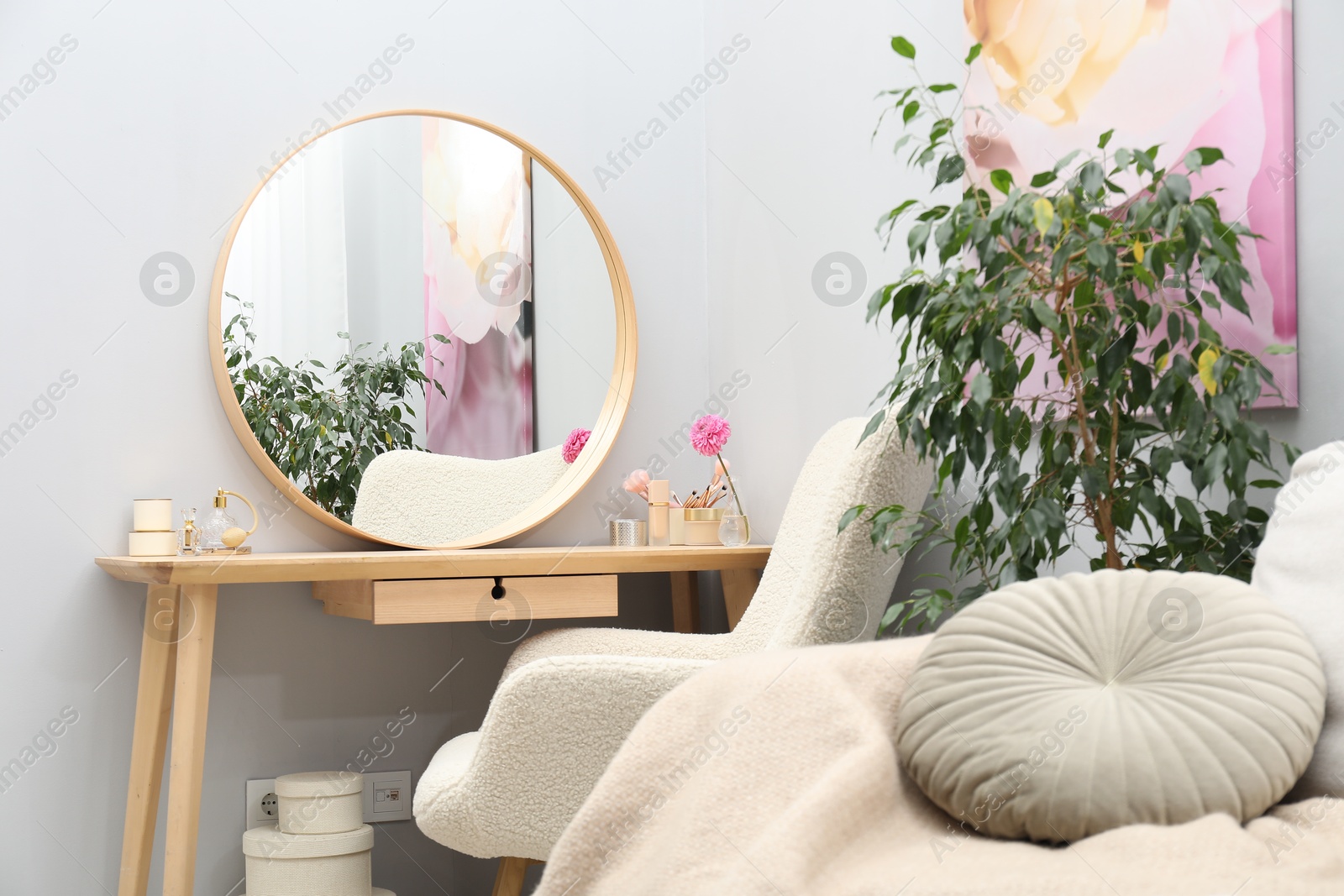 Photo of Mirror, dressing table, houseplant, sofa and armchair indoors. Interior design