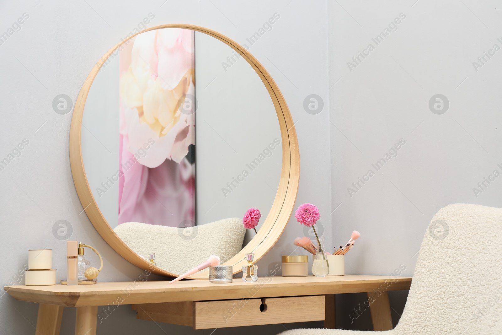 Photo of Mirror, dressing table and armchair indoors. Interior design