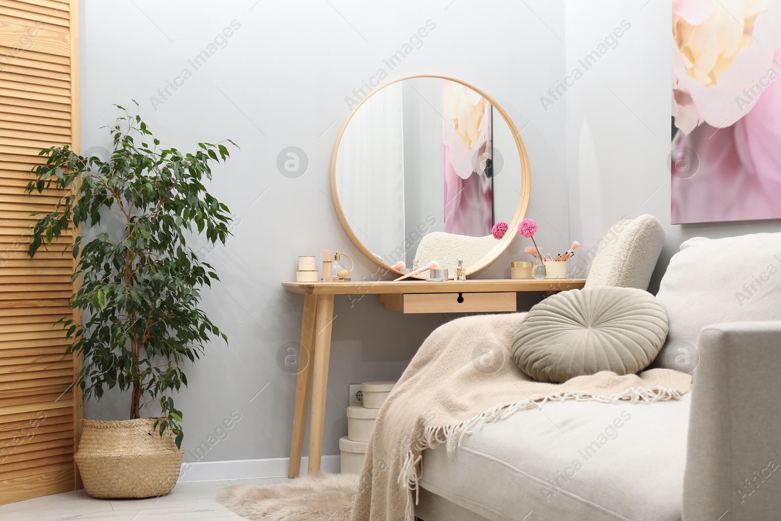 Photo of Mirror, dressing table, houseplant, sofa and armchair indoors. Interior design