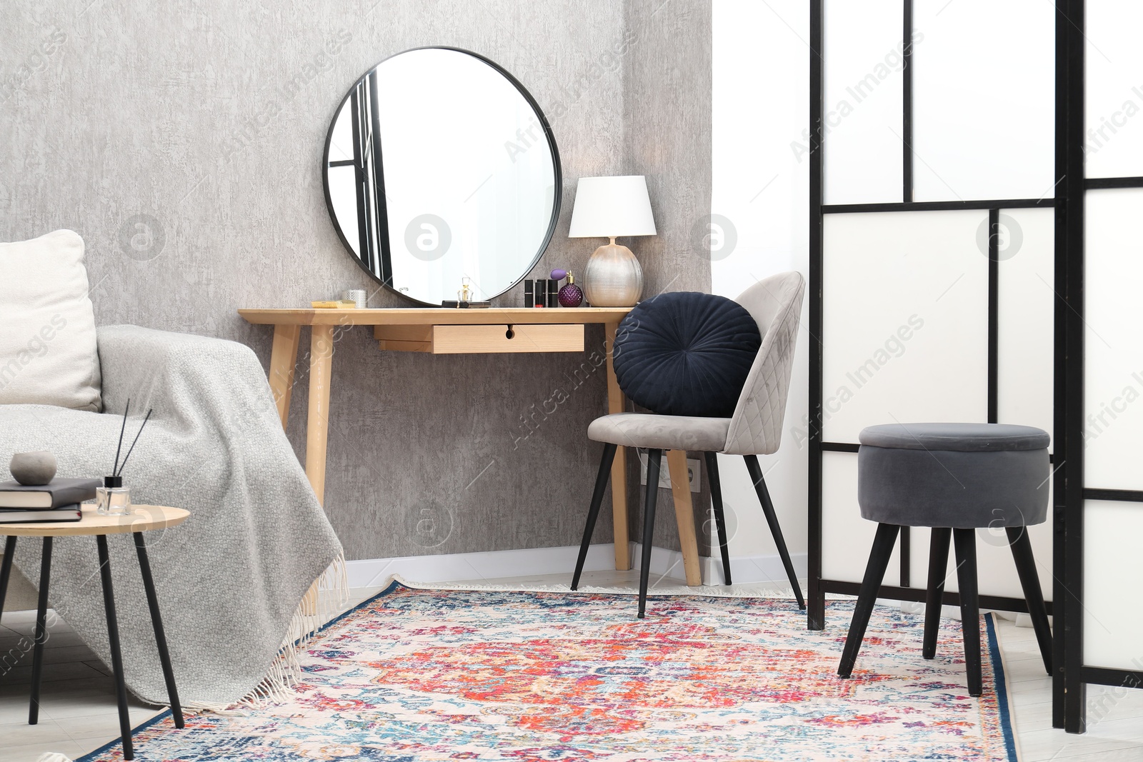 Photo of Mirror, dressing table, chairs and folding screen indoors. Interior design