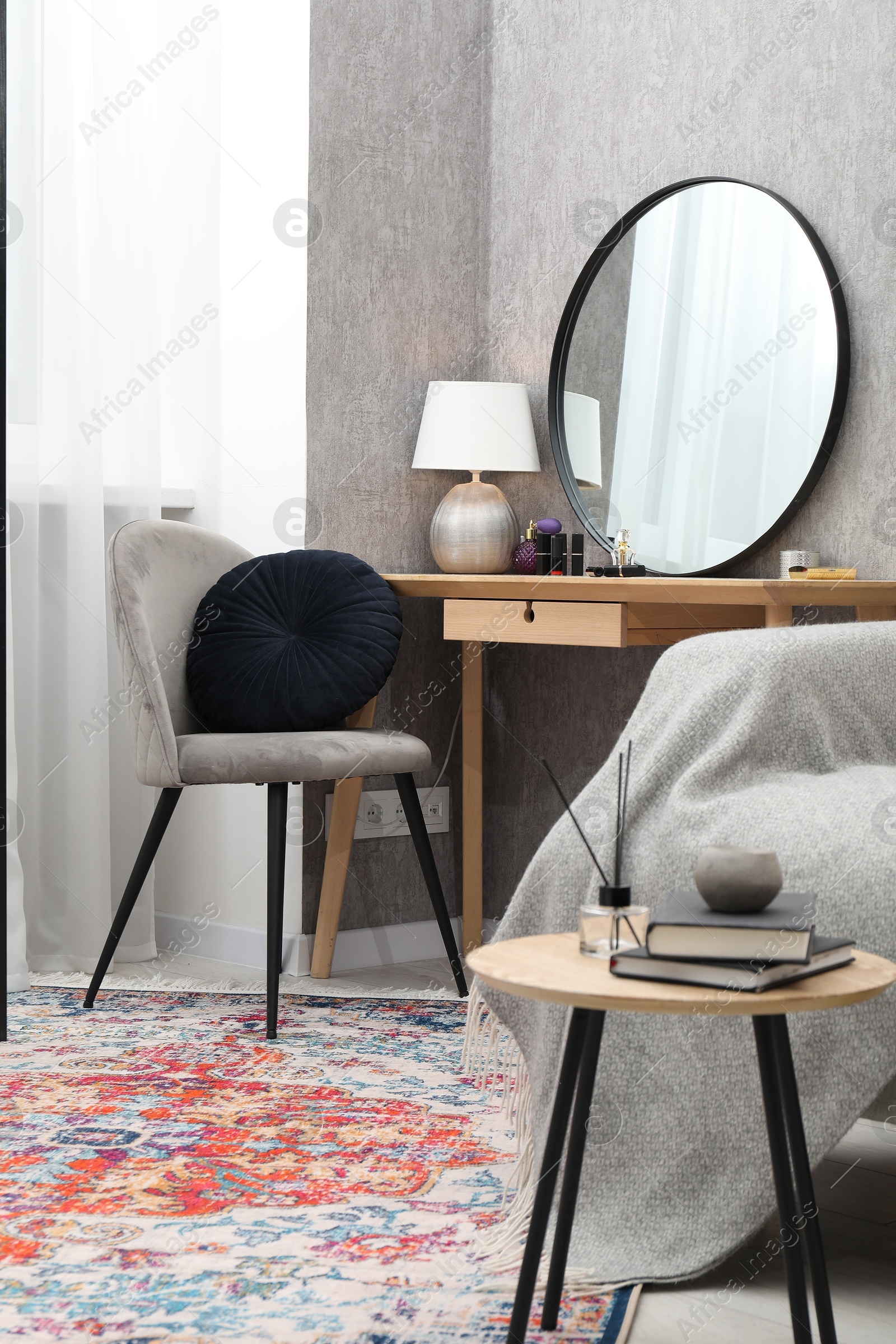 Photo of Mirror, dressing table, chairs and folding screen indoors. Interior design