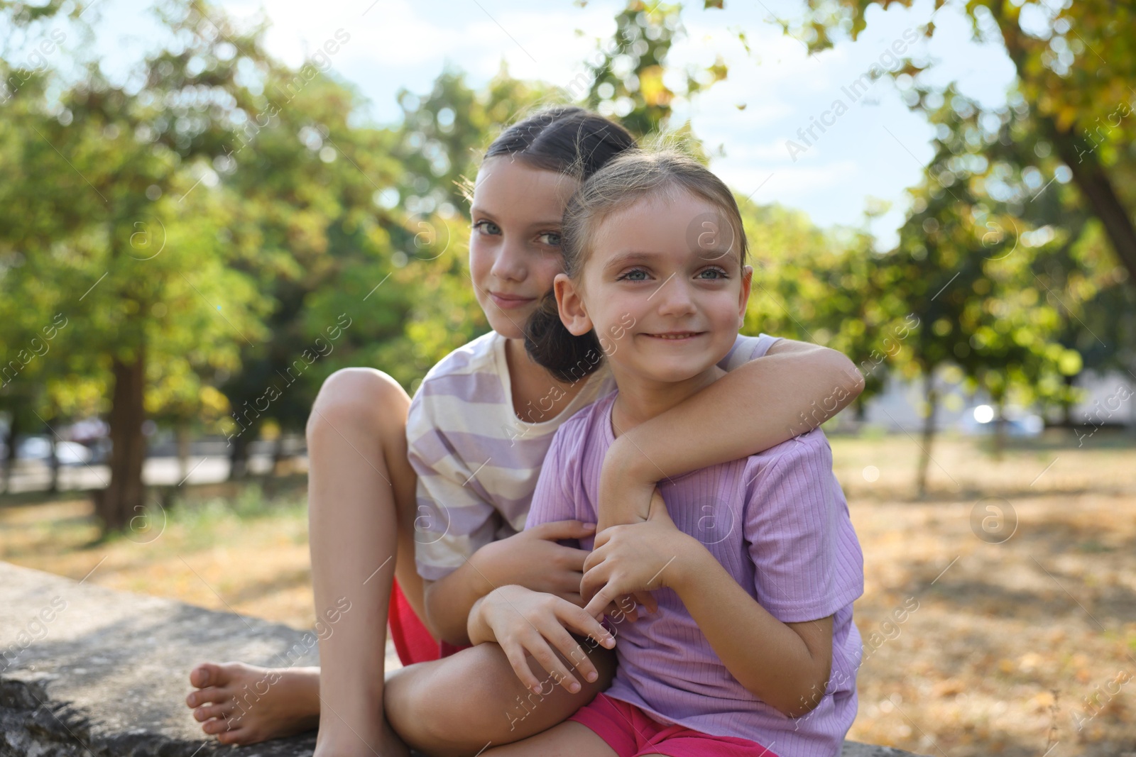 Photo of Portrait of cute little sisters in park