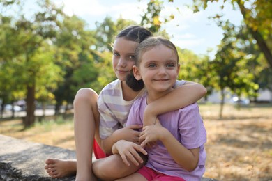 Photo of Portrait of cute little sisters in park