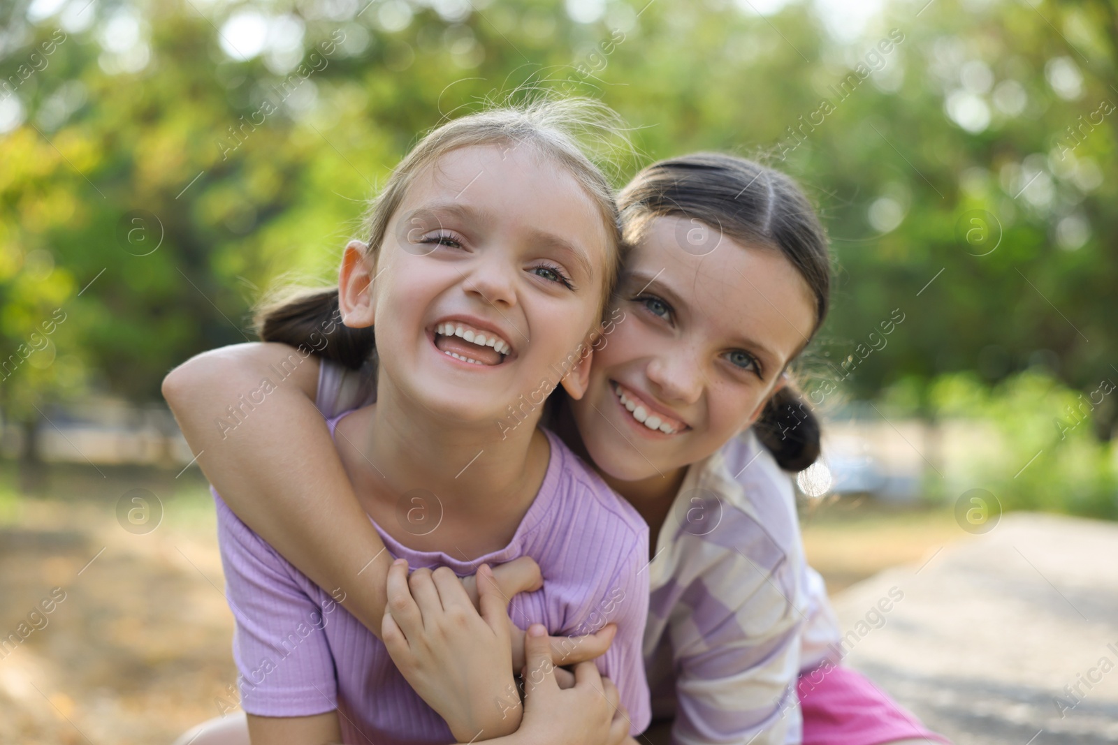 Photo of Portrait of cute little sisters in park