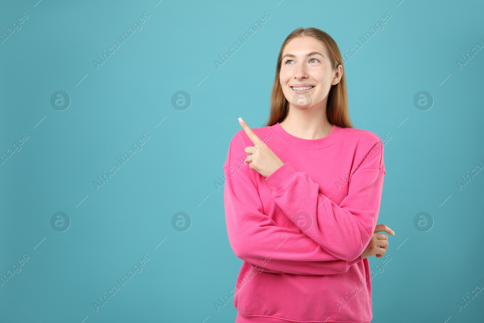 Photo of Girl with braces on light blue background, space for text