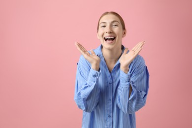 Photo of Smiling girl with braces on pink background, space for text