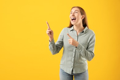 Photo of Smiling girl with braces on orange background, space for text