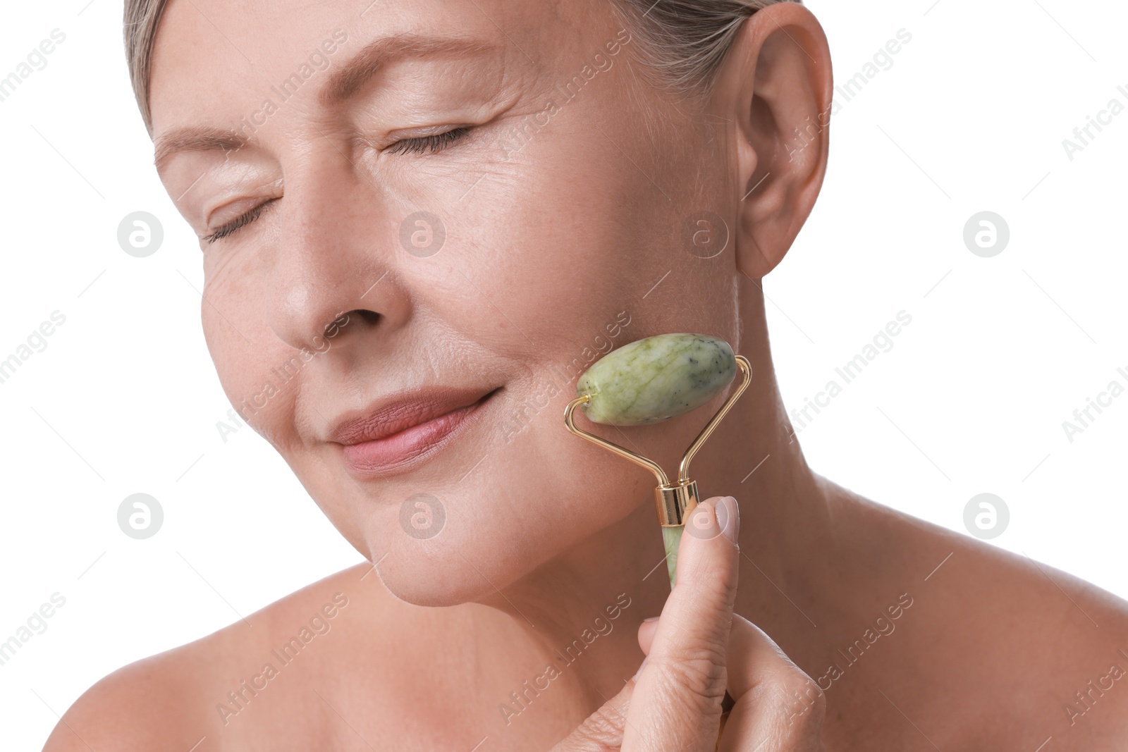 Photo of Beautiful woman doing facial massage with roller on white background, closeup