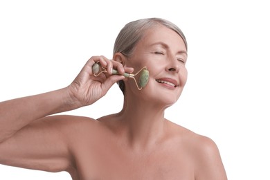 Photo of Beautiful woman doing facial massage with roller on white background