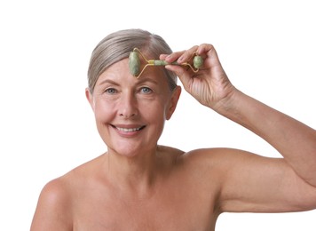 Beautiful woman doing facial massage with roller on white background