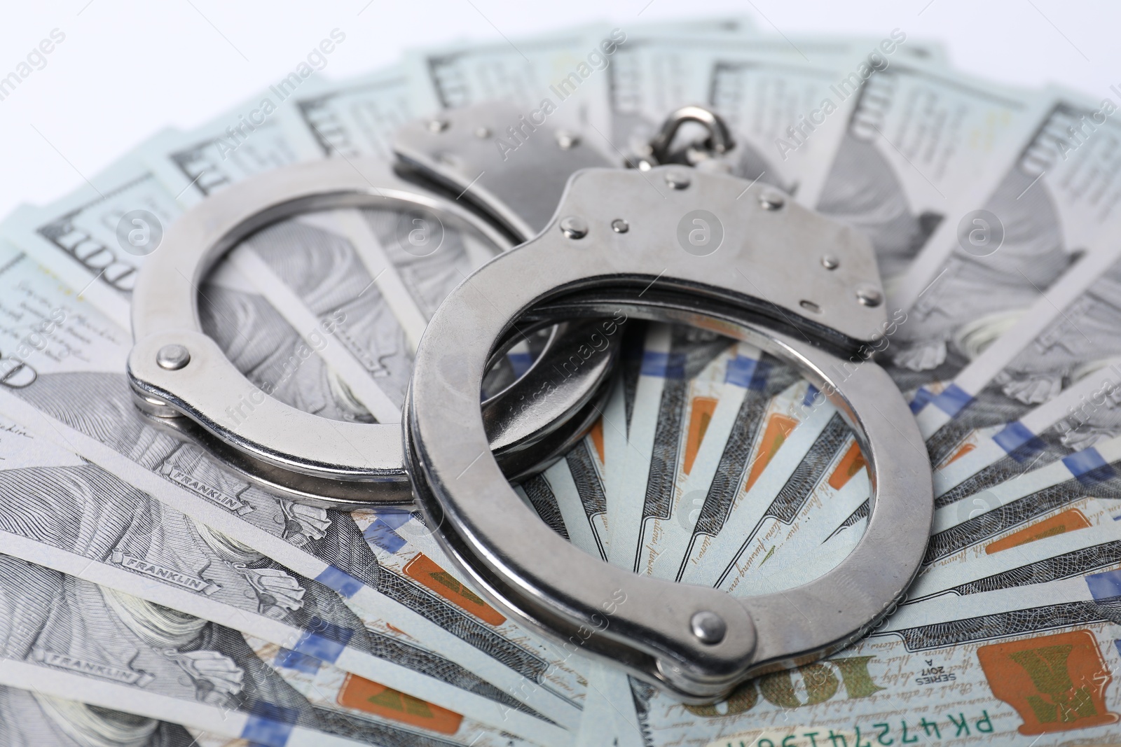 Photo of Corruption concept. Handcuffs on dollar banknotes, closeup