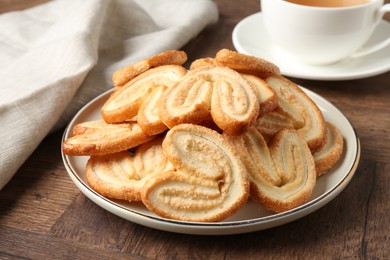 Tasty french palmier cookies on wooden table, closeup