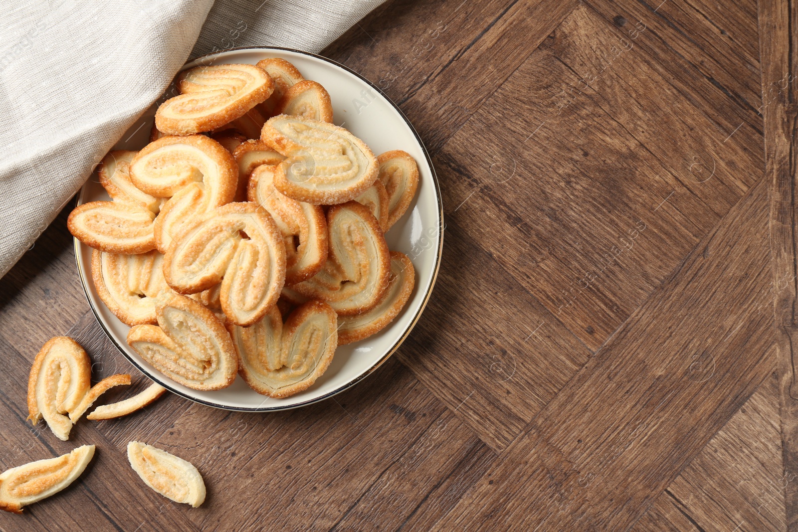 Photo of Tasty french palmier cookies on wooden table, top view. Space for text