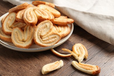 Tasty french palmier cookies on wooden table, closeup