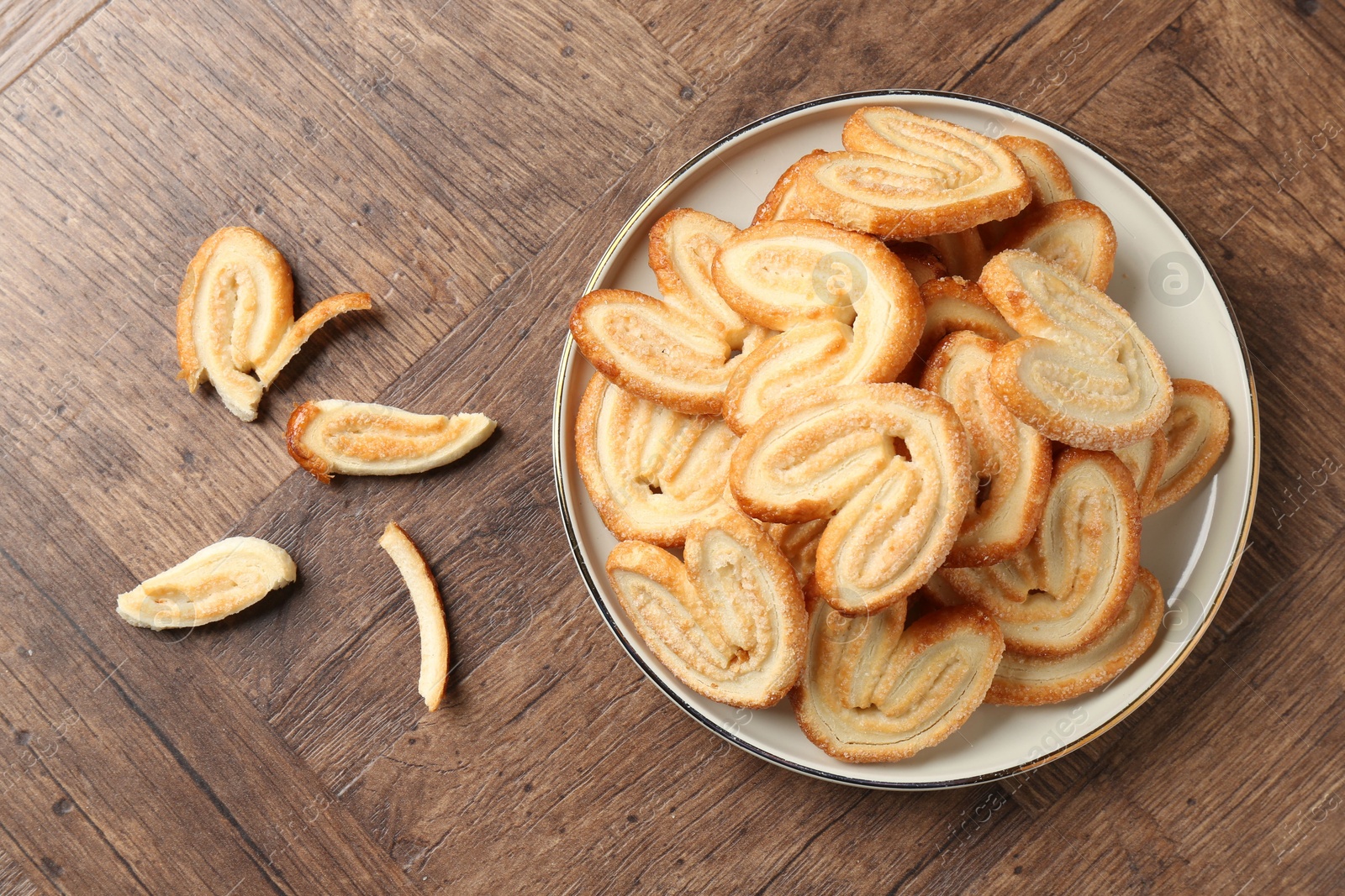 Photo of Tasty french palmier cookies on wooden table, top view