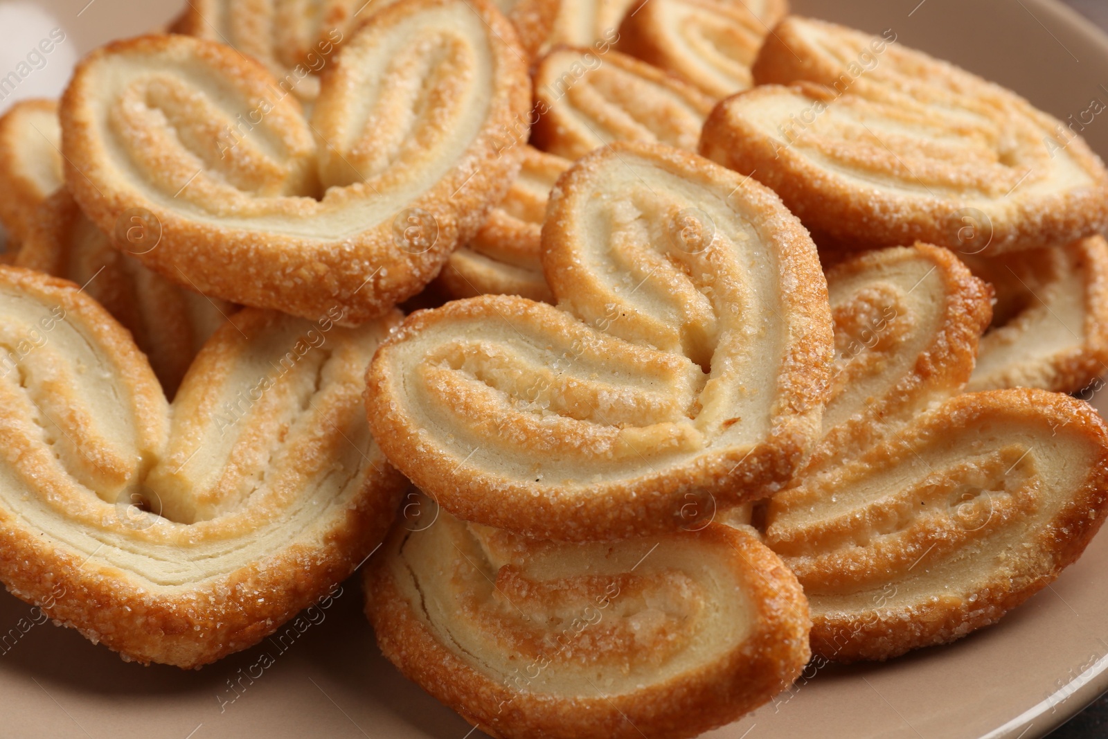 Photo of Delicious sweet palmier cookies on plate, closeup