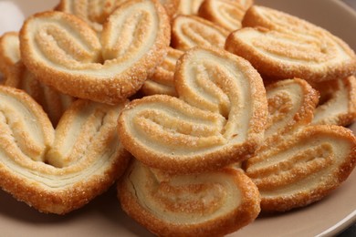 Delicious sweet palmier cookies on plate, closeup