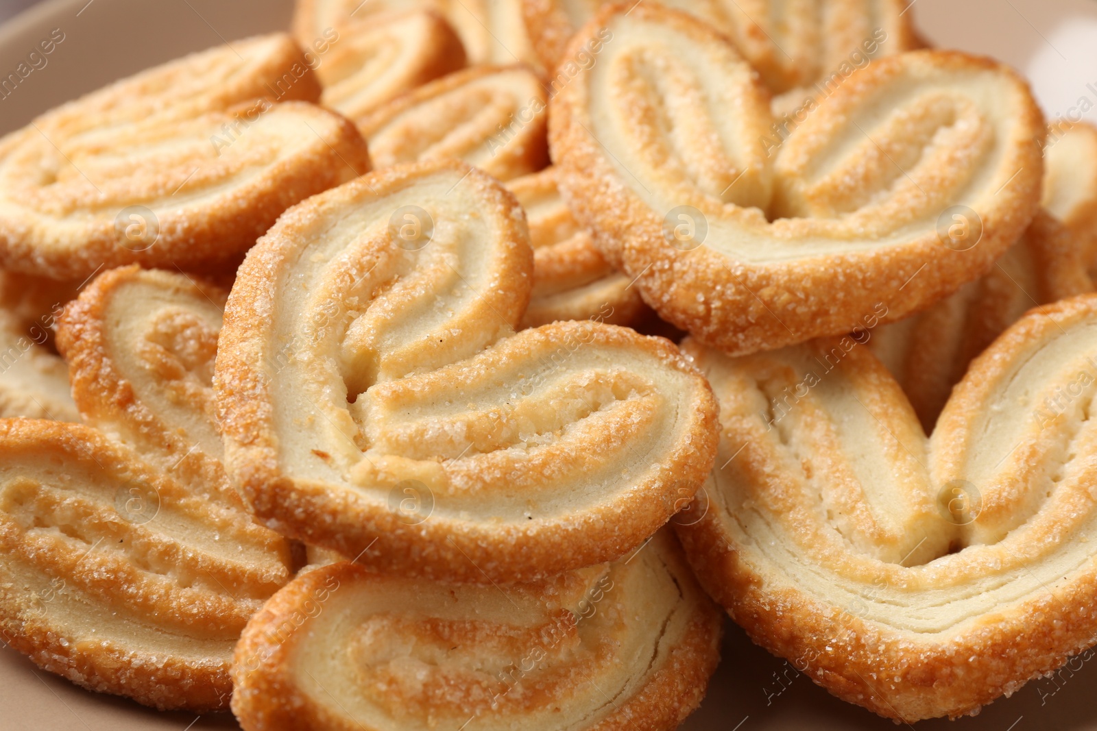 Photo of Delicious sweet palmier cookies as background, closeup