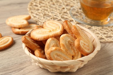 Photo of Delicious sweet palmier cookies on wooden table