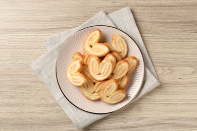 Photo of Delicious sweet palmier cookies on wooden table, top view