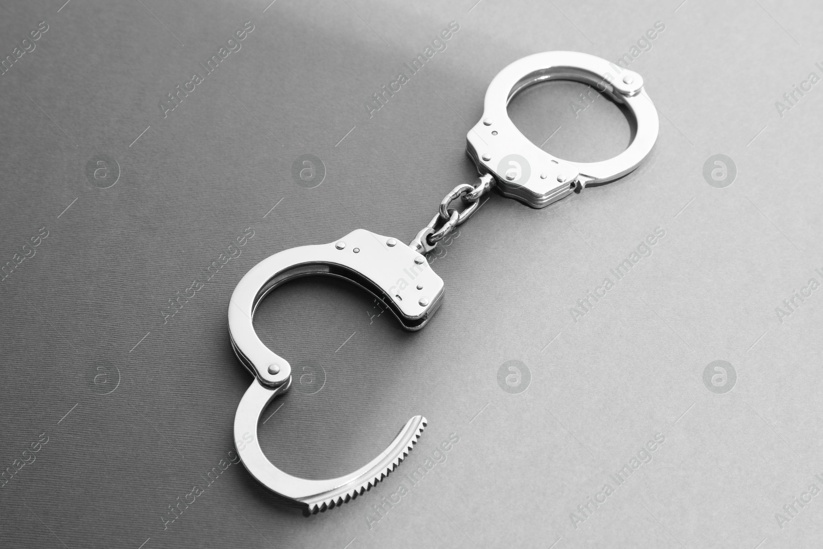 Photo of New classic chain handcuffs on grey background