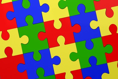 Image of Many colorful puzzle pieces as background. Symbol of autism