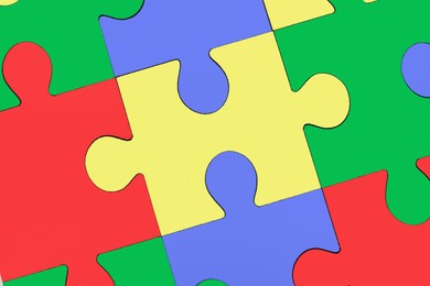 Image of Many colorful puzzle pieces as background. Symbol of autism