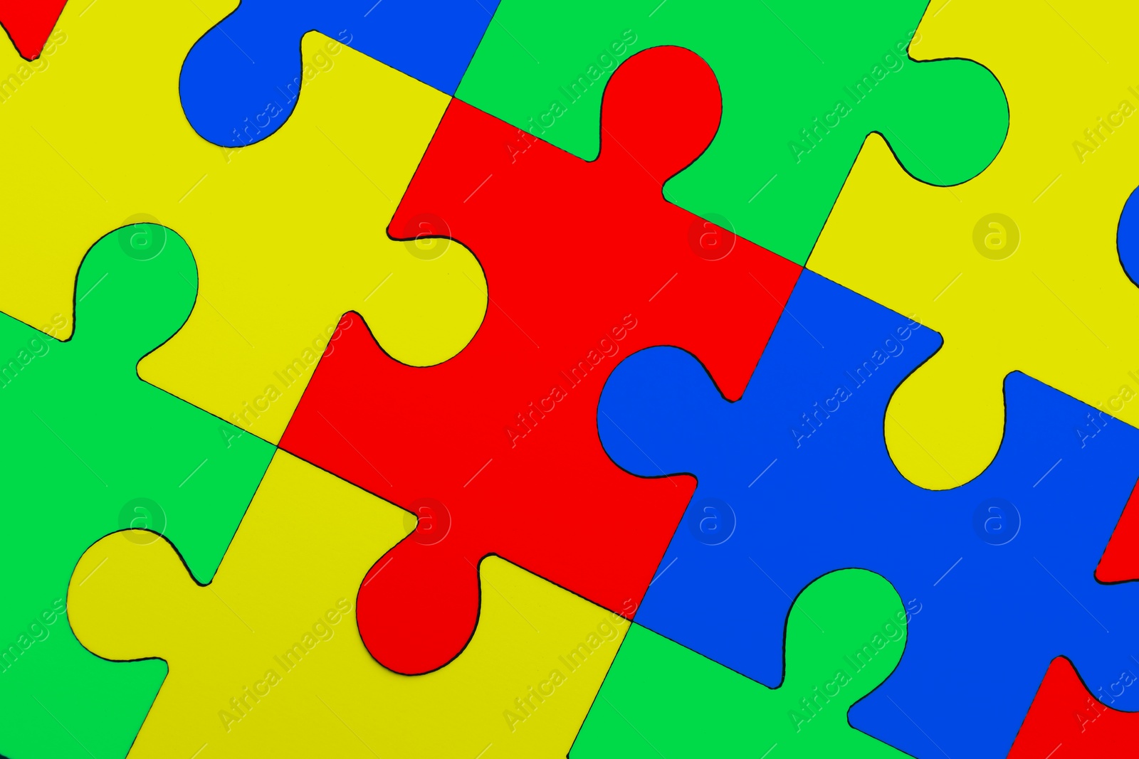 Image of Many colorful puzzle pieces as background. Symbol of autism