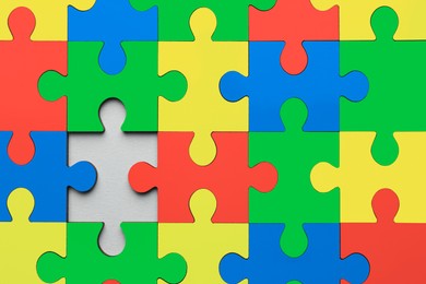 Image of Many colorful puzzle pieces as background. Symbol of autism