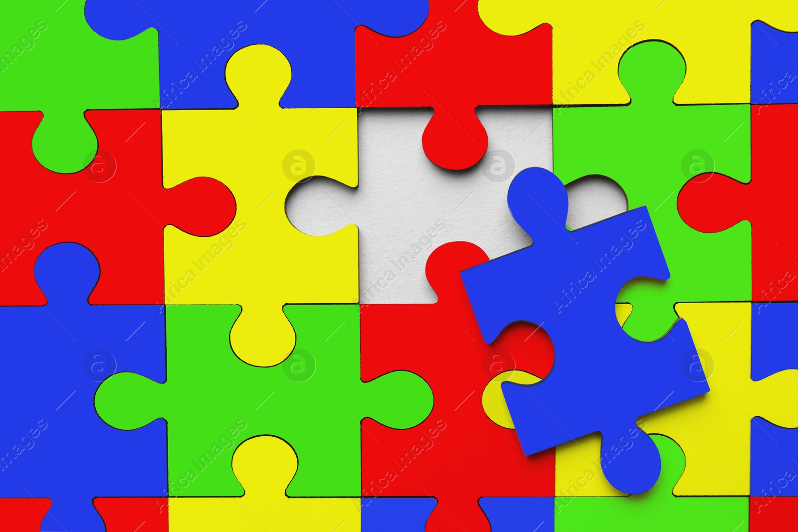 Image of Many colorful puzzle pieces as background. Symbol of autism