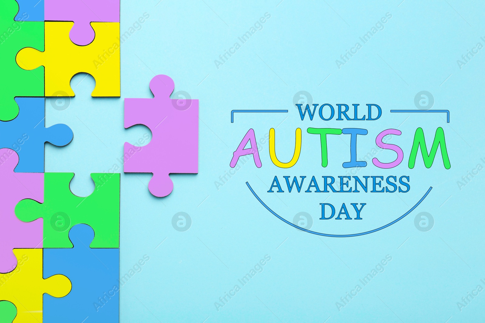 Image of World Autism Awareness Day text and colorful puzzle pieces on light blue background, top view