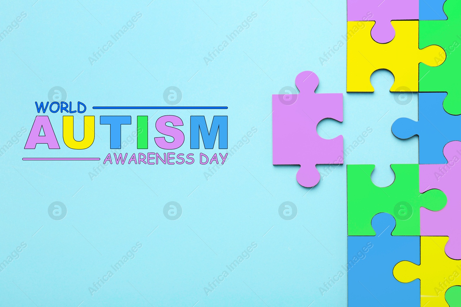 Image of World Autism Awareness Day text and colorful puzzle pieces on light blue background, top view