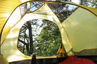 Photo of Modern camping tent in forest at summer, low angle view